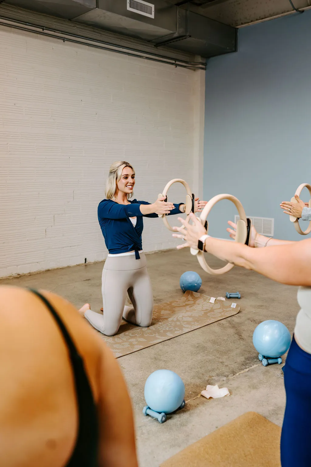 Maureen leading a class with Pilates rings